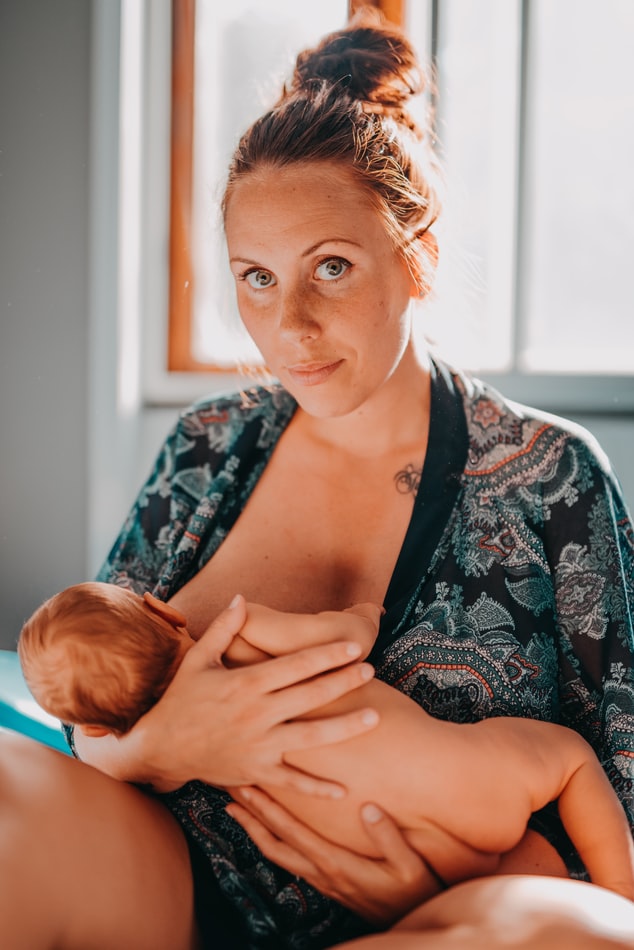 A MOTHER GIVING HER CHILD BREAST TO SUCK