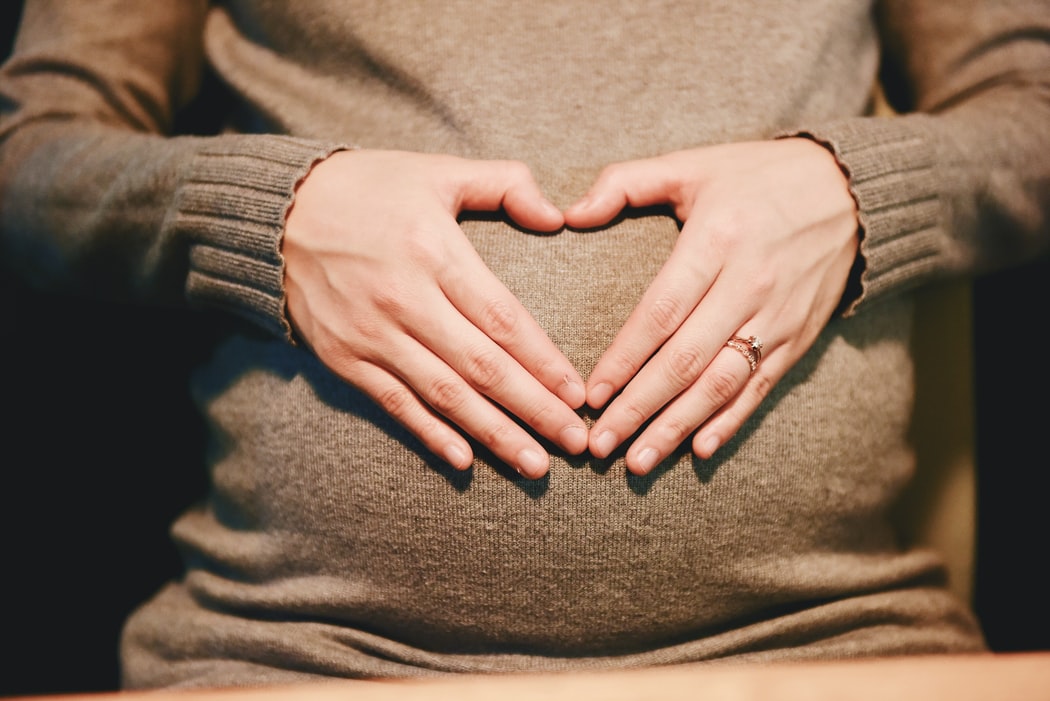 picture of a pregnant woman holding her tummy