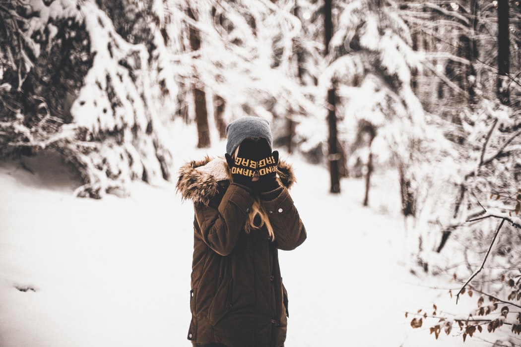 a shy girl staying in snow environment