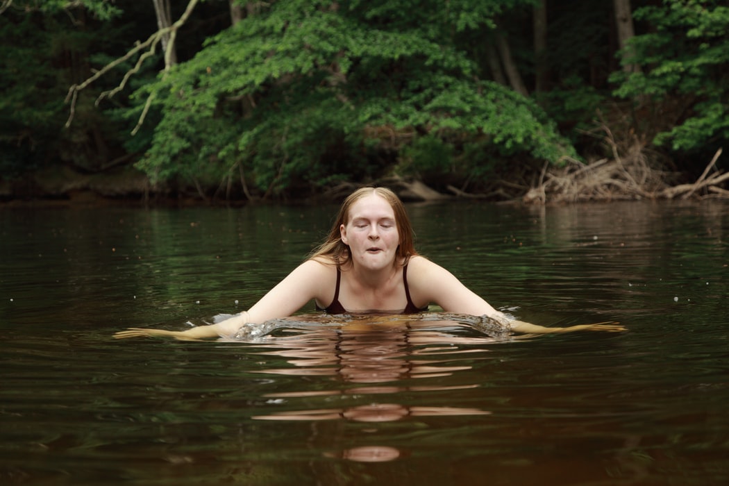 woman in body of water during day time