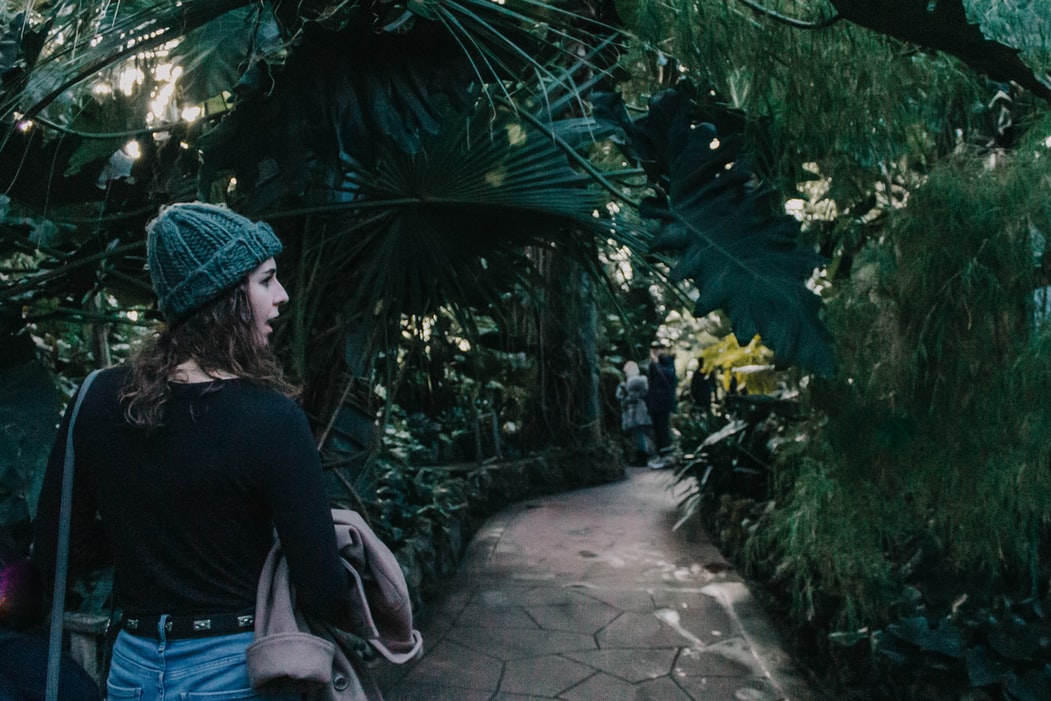 woman walking on concret pathway looking her right