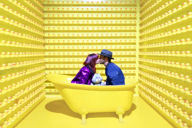 MAN AND WOMAN KISSING IN A BATHTUB