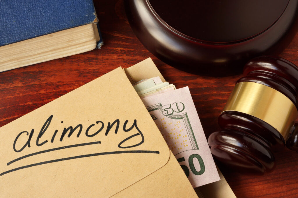 Alimony concept. An envelope with cash on a table.